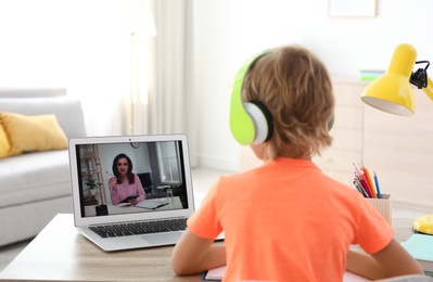 Little boy studying with teacher via video conference at home. Distance learning during COVID-19 pandemic