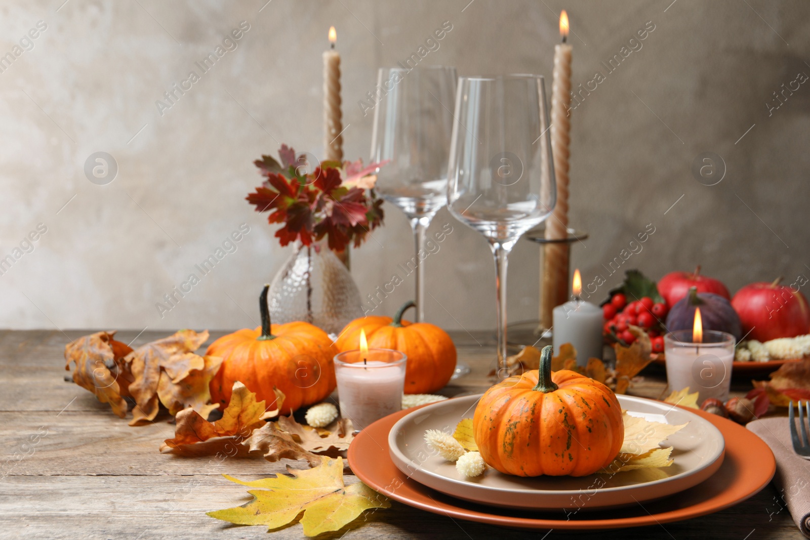 Photo of Beautiful autumn place setting and decor on wooden table, space for text