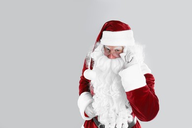 Photo of Portrait of Santa Claus on light grey background. Space for text