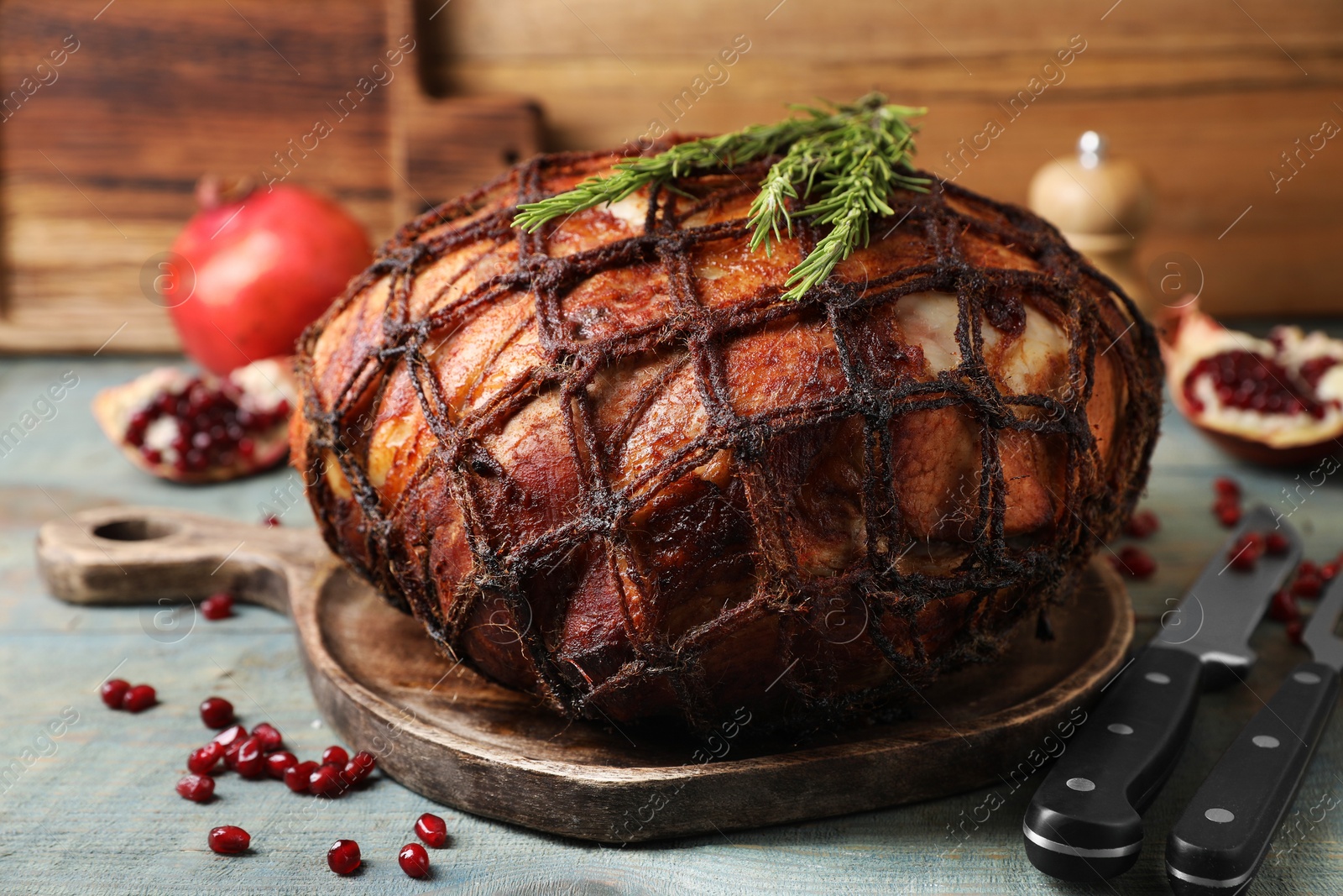 Photo of Delicious baked ham, pomegranate seeds and rosemary on rustic wooden table