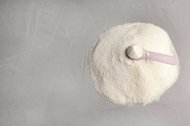 Photo of Pile of protein powder, scoop and space for text on grey background. Preparing shake