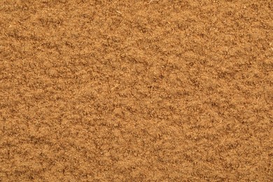 Photo of Dry aromatic cinnamon powder as background, top view