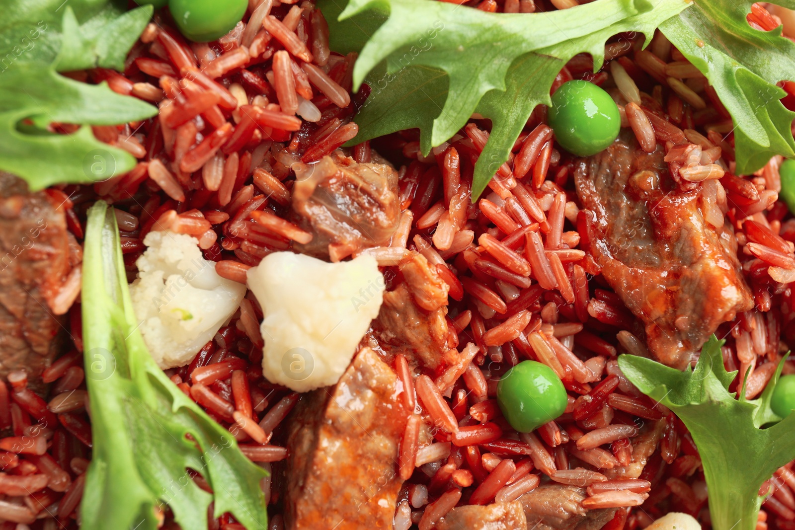 Photo of Tasty brown rice with meat and vegetables as background, top view