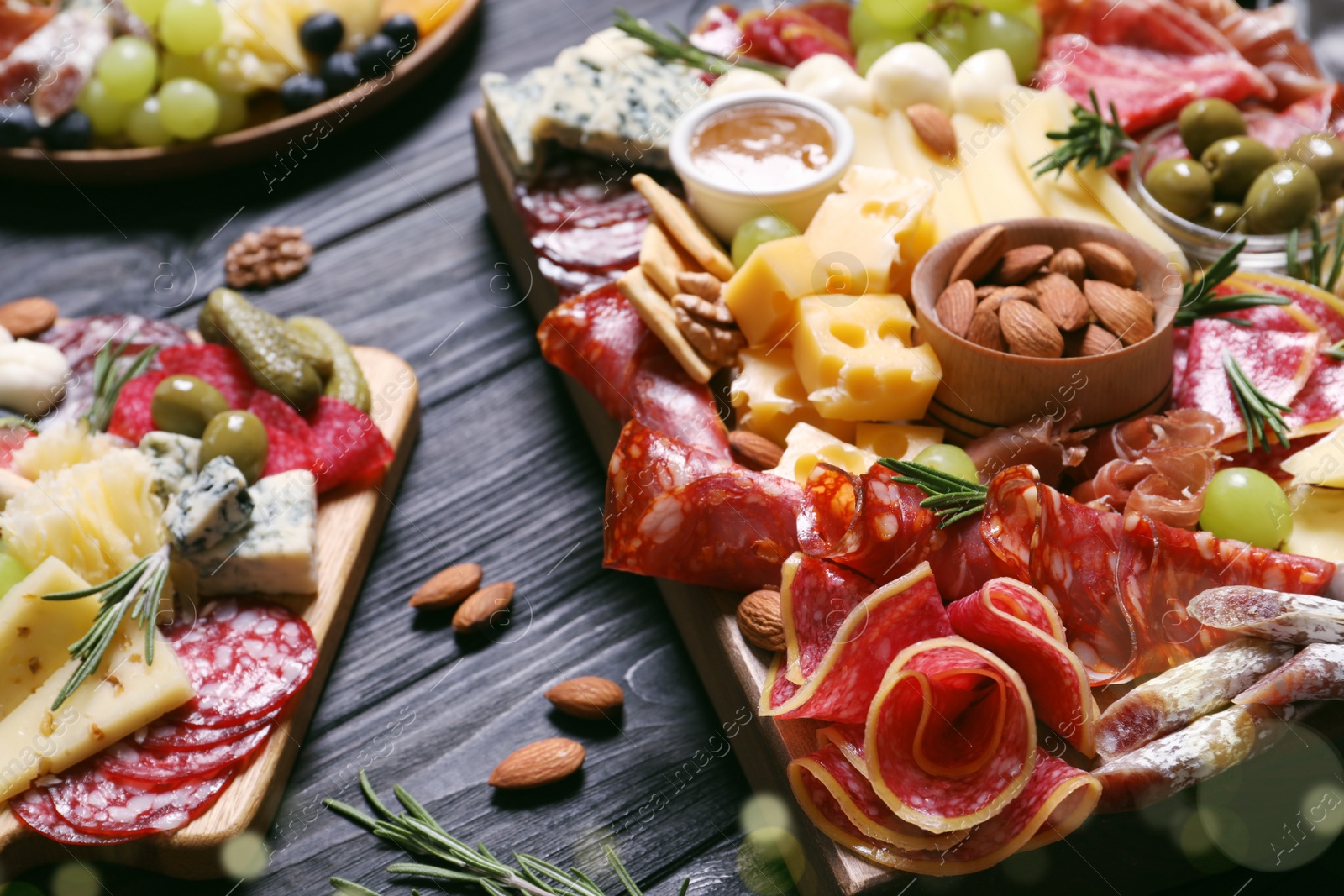 Photo of Tasty assorted appetizers served on black wooden table