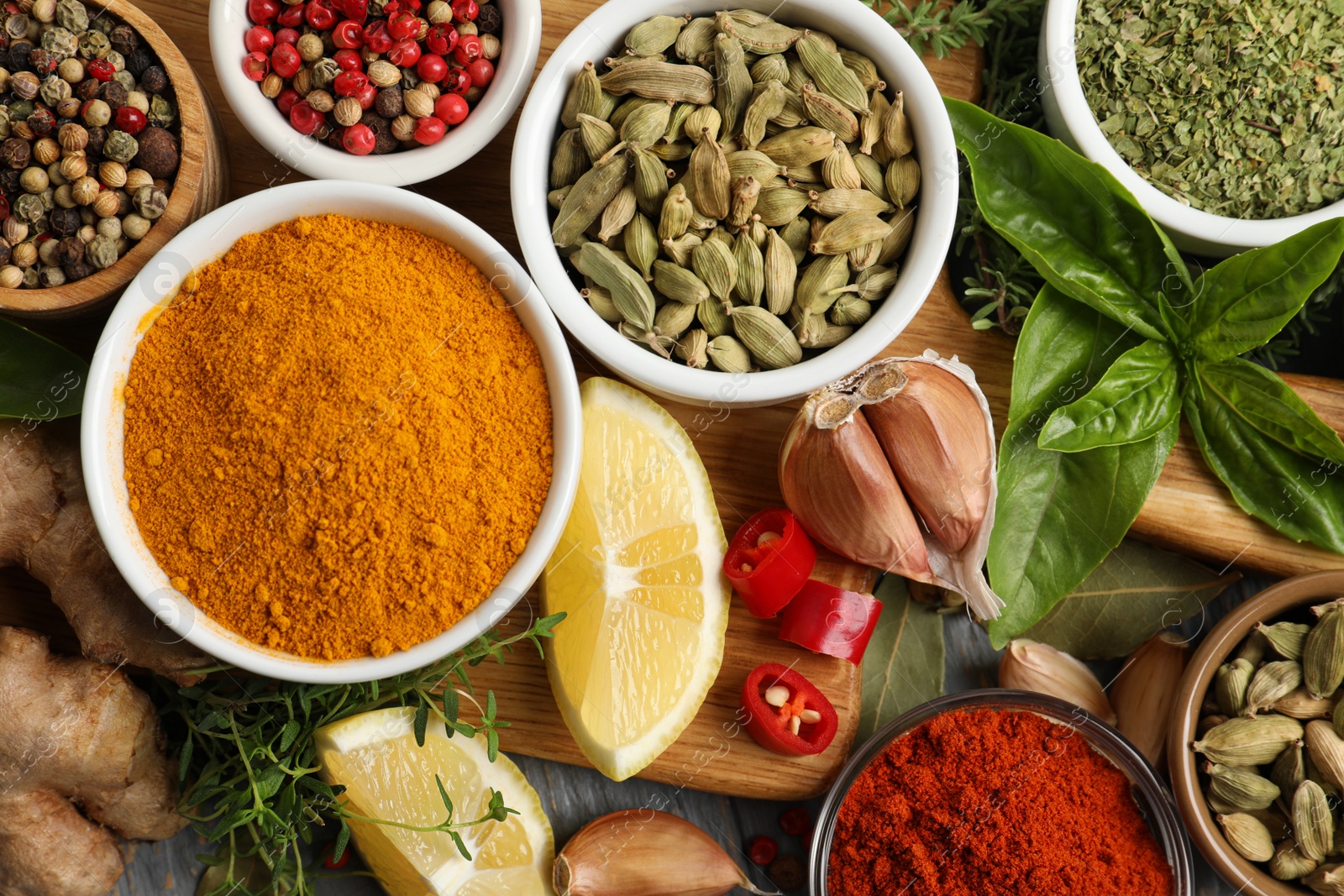 Photo of Different natural spices and herbs on table, flat lay