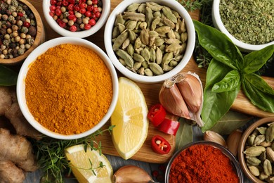 Different natural spices and herbs on table, flat lay