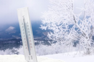 Image of Thermometer in snow showing temperature below zero outdoors on winter day