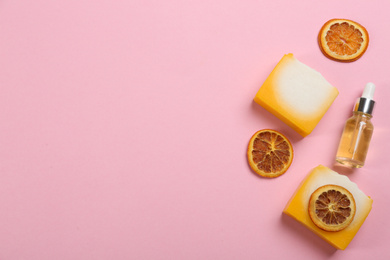 Photo of Flat lay composition with natural handmade soap and ingredients on pink background. Space for text