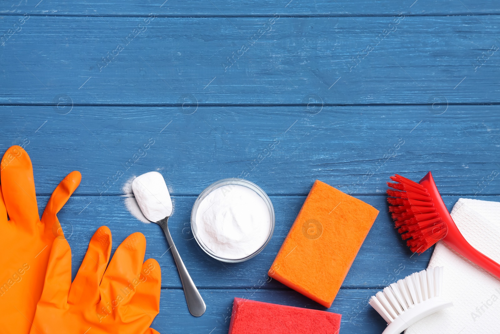 Photo of Flat lay composition with baking soda on blue wooden table. Space for text