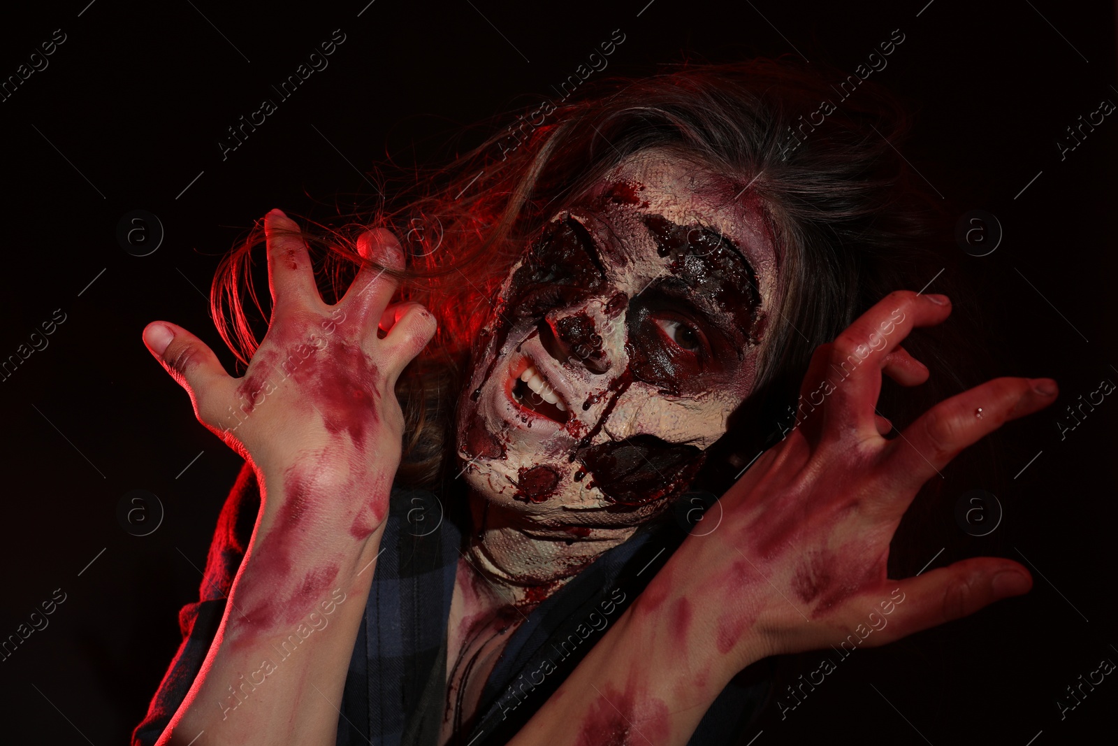 Photo of Scary zombie on dark background. Halloween monster