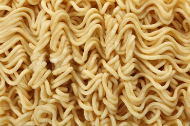 Photo of Quick cooking noodles as background, closeup view