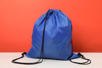 Photo of Blue drawstring bag on white wooden table