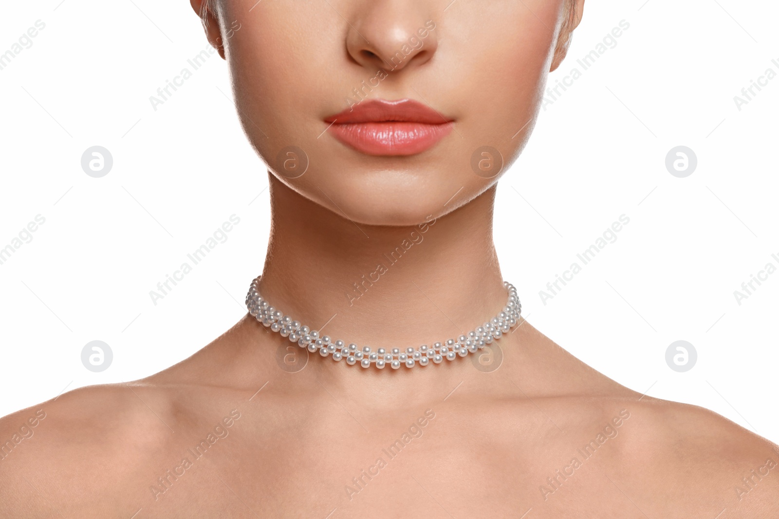 Photo of Young woman wearing elegant pearl necklace on white background, closeup