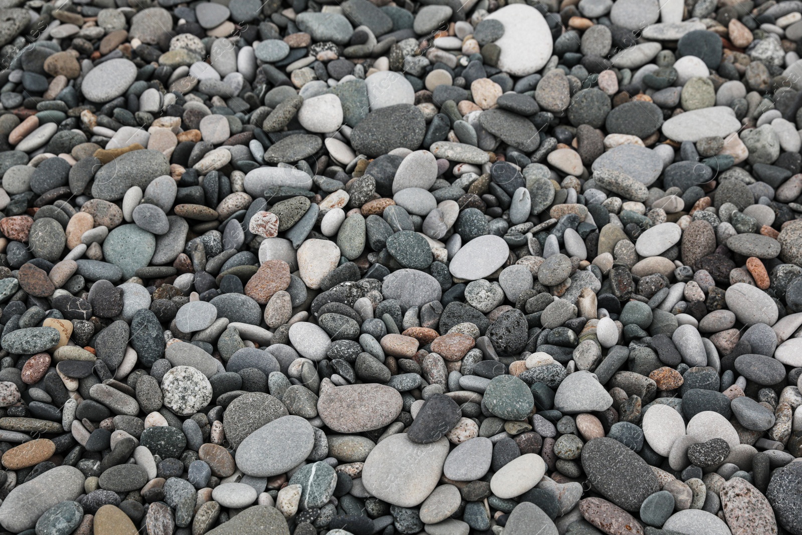 Photo of Surface covered with many different pebbles as background