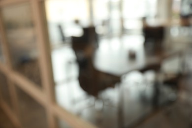 Photo of Blurred view of cozy workplace zone with table and chairs in office