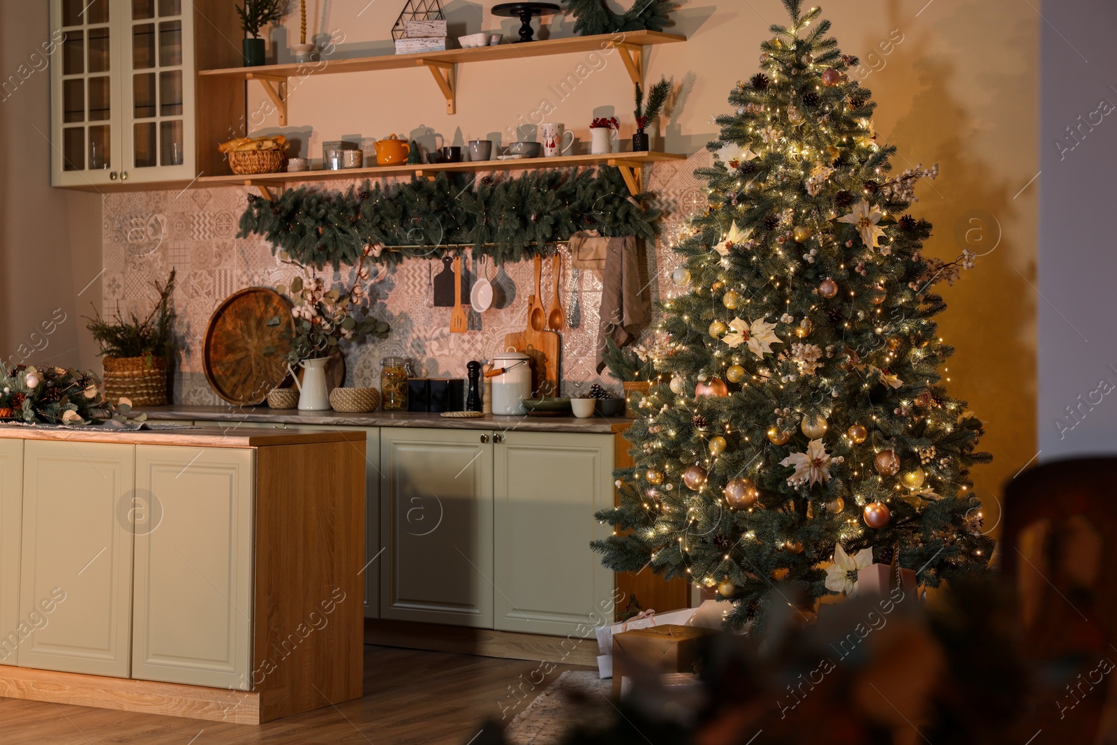 Photo of Stylish kitchen with Christmas tree and festive decor. Interior design