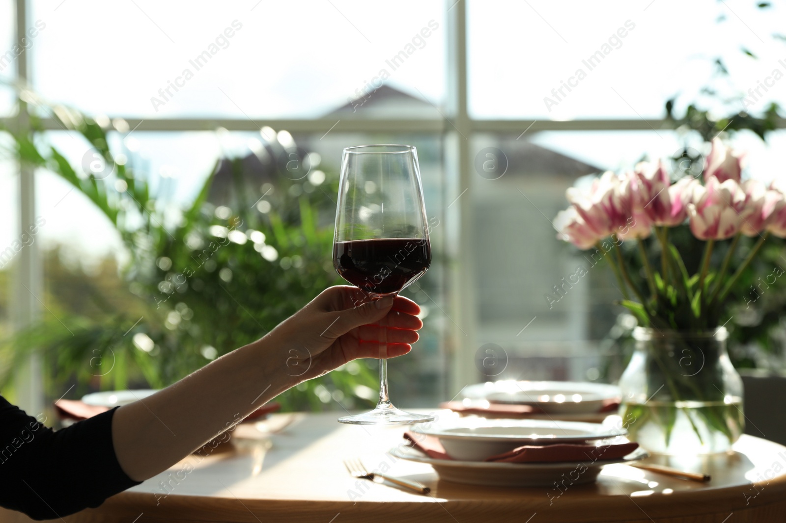 Photo of Woman with glass of wine in restaurant, closeup