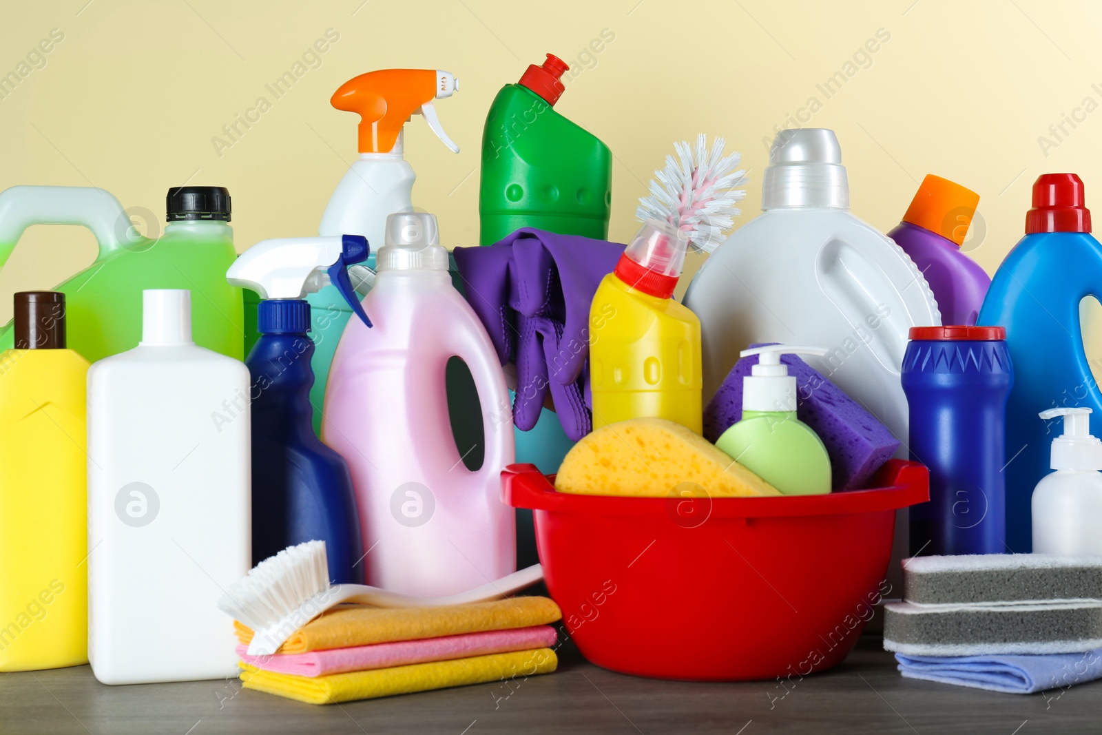 Photo of Different cleaning supplies and tools on wooden table