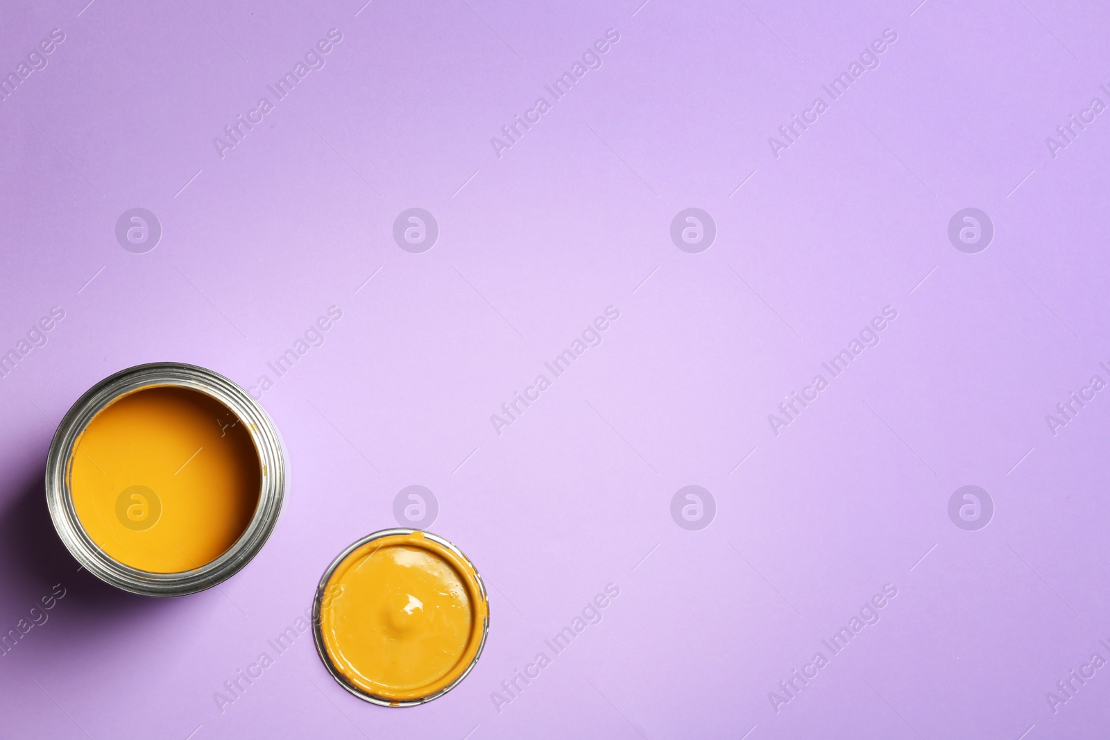 Photo of Open paint can and space for text on color background, top view