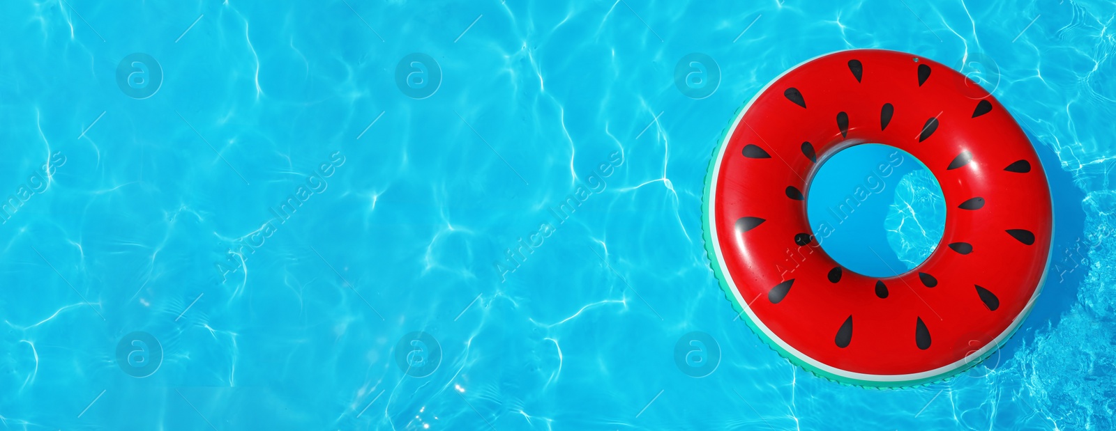 Image of Inflatable ring floating in swimming pool on sunny day, top view with space for text. Banner design