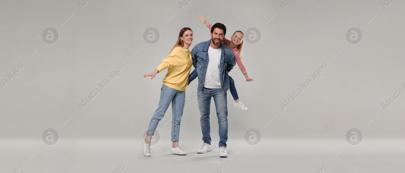 Image of Happy family with child on light grey background. Banner design