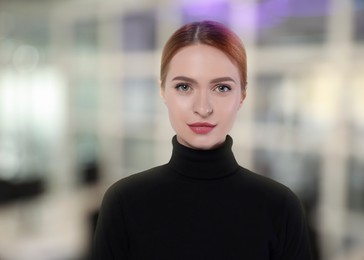 Image of Portrait of confident woman in office. Pretty girl on blurred background