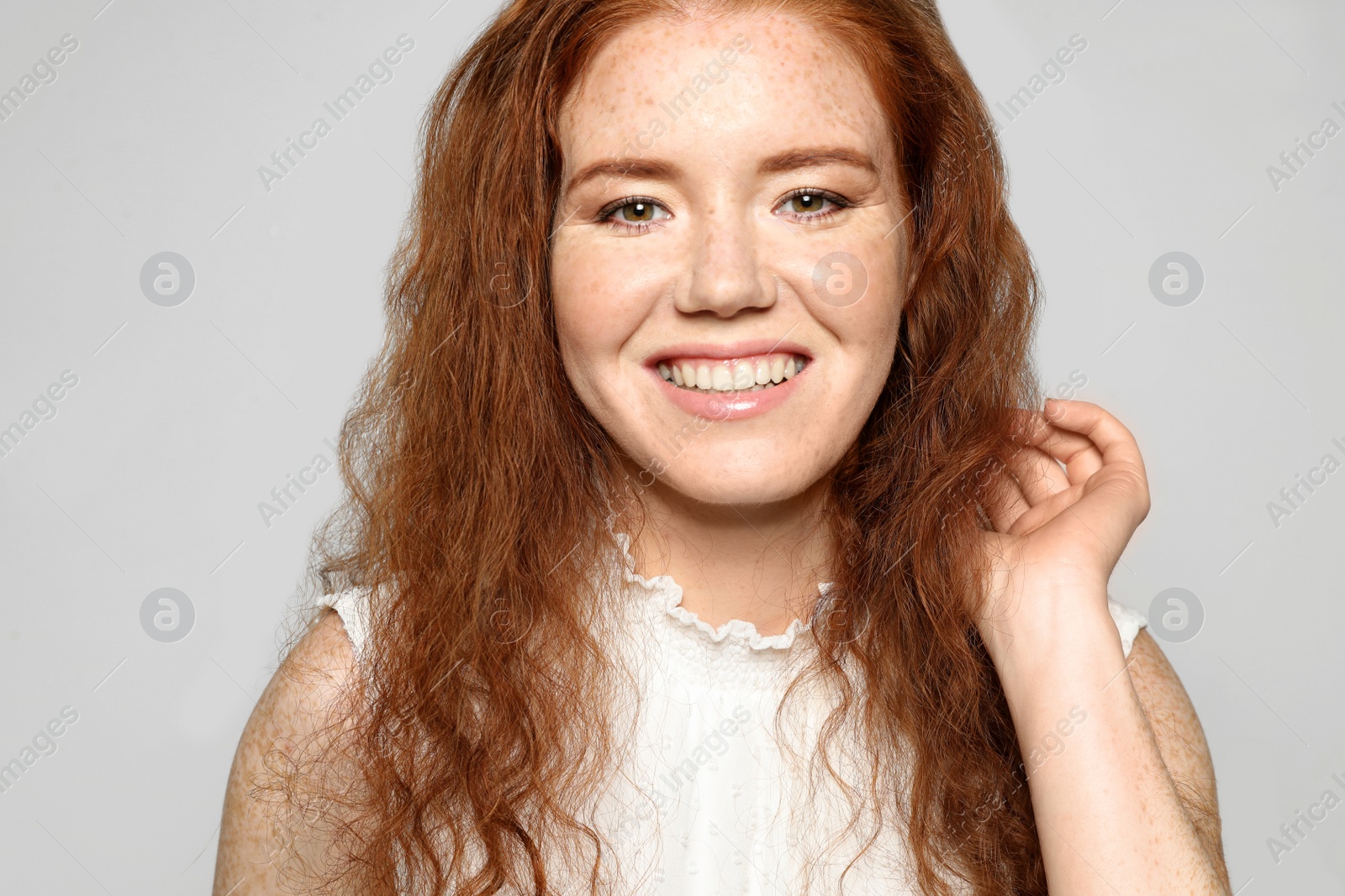 Photo of Portrait of young woman with beautiful face on grey background, closeup