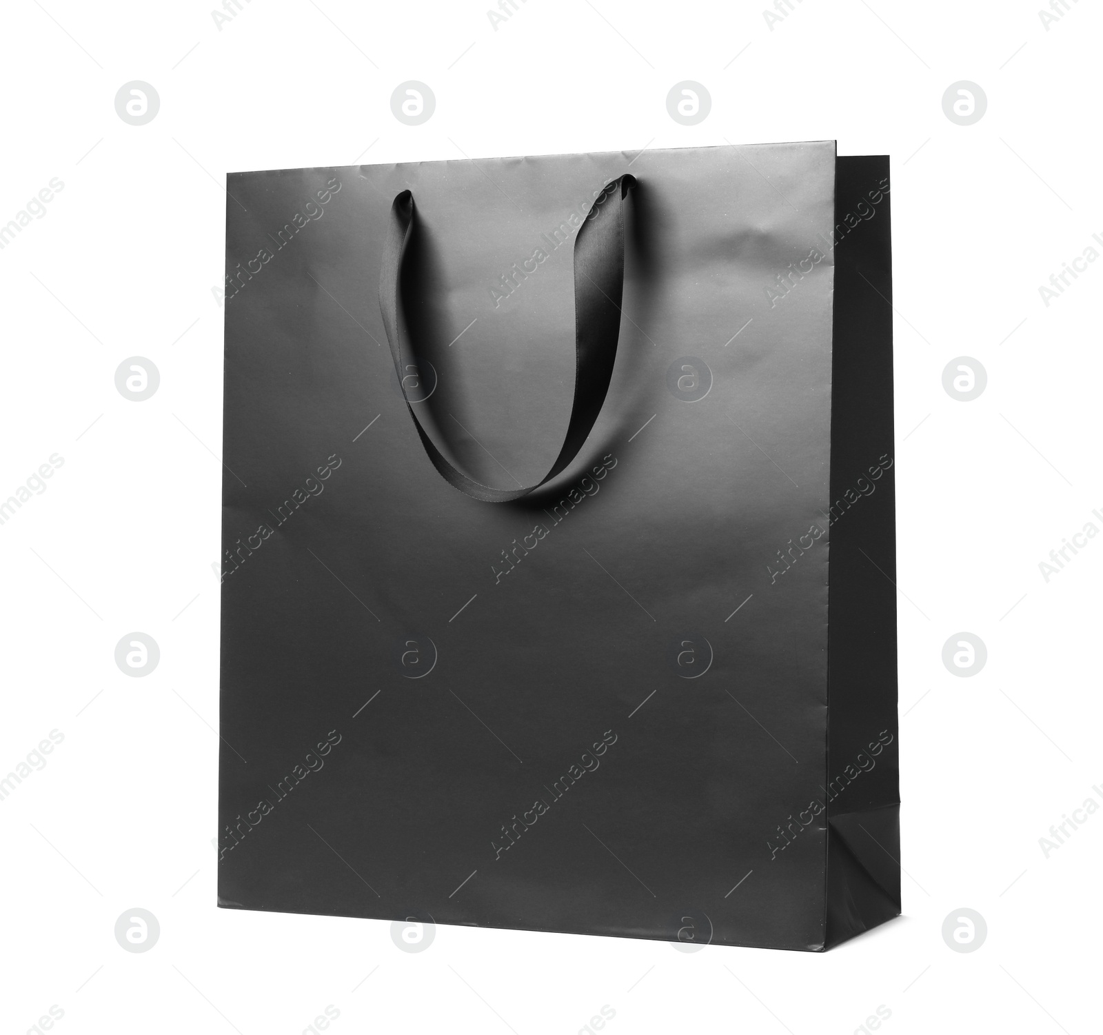 Photo of Paper shopping bag with ribbon handles on white background. Mockup for design