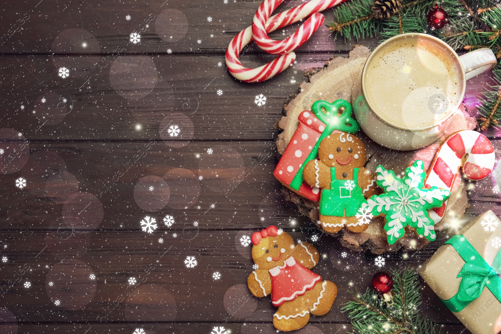 Image of Decorated Christmas cookies and cup of delicious drink on wooden table, flat lay. Space for text