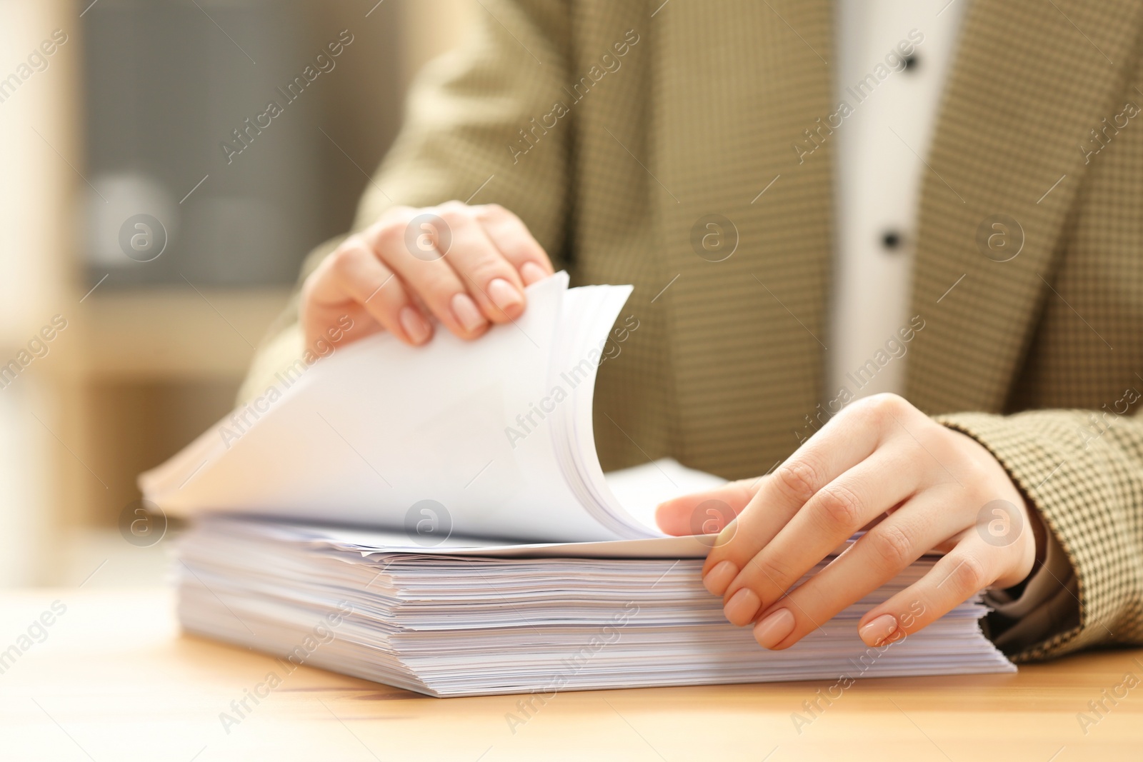 Photo of Woman working with documents at table in office, closeup