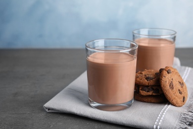 Photo of Glasses with tasty chocolate milk on table, space for text. Dairy drink