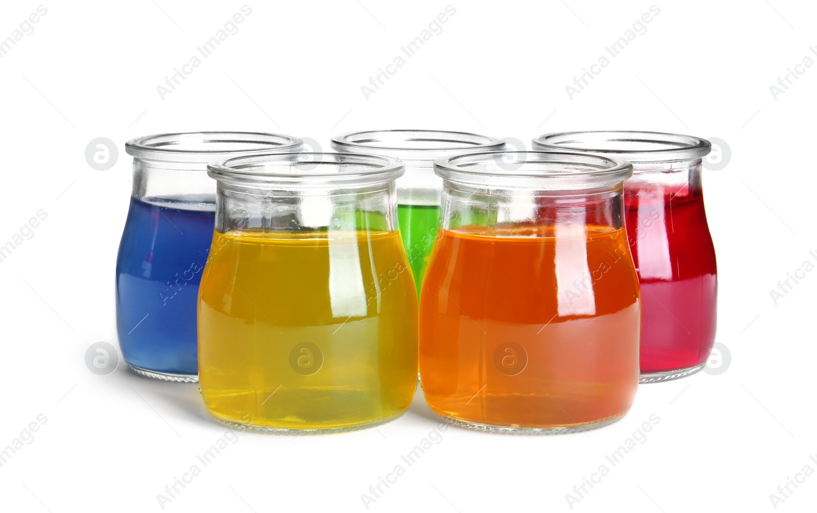 Photo of Tasty jelly desserts in glass jars on white background