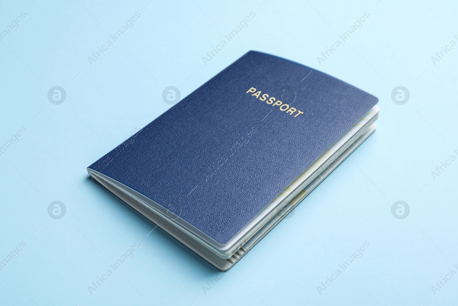 Photo of Blank passport on light blue background, closeup