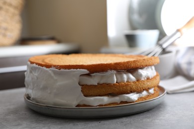 Photo of Delicious homemade layer cake with cream on grey table, closeup