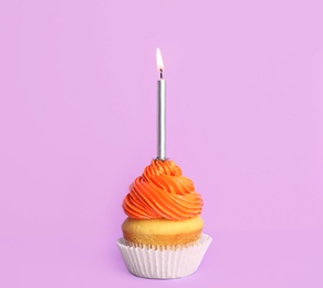 Photo of Birthday cupcake with candle on violet background