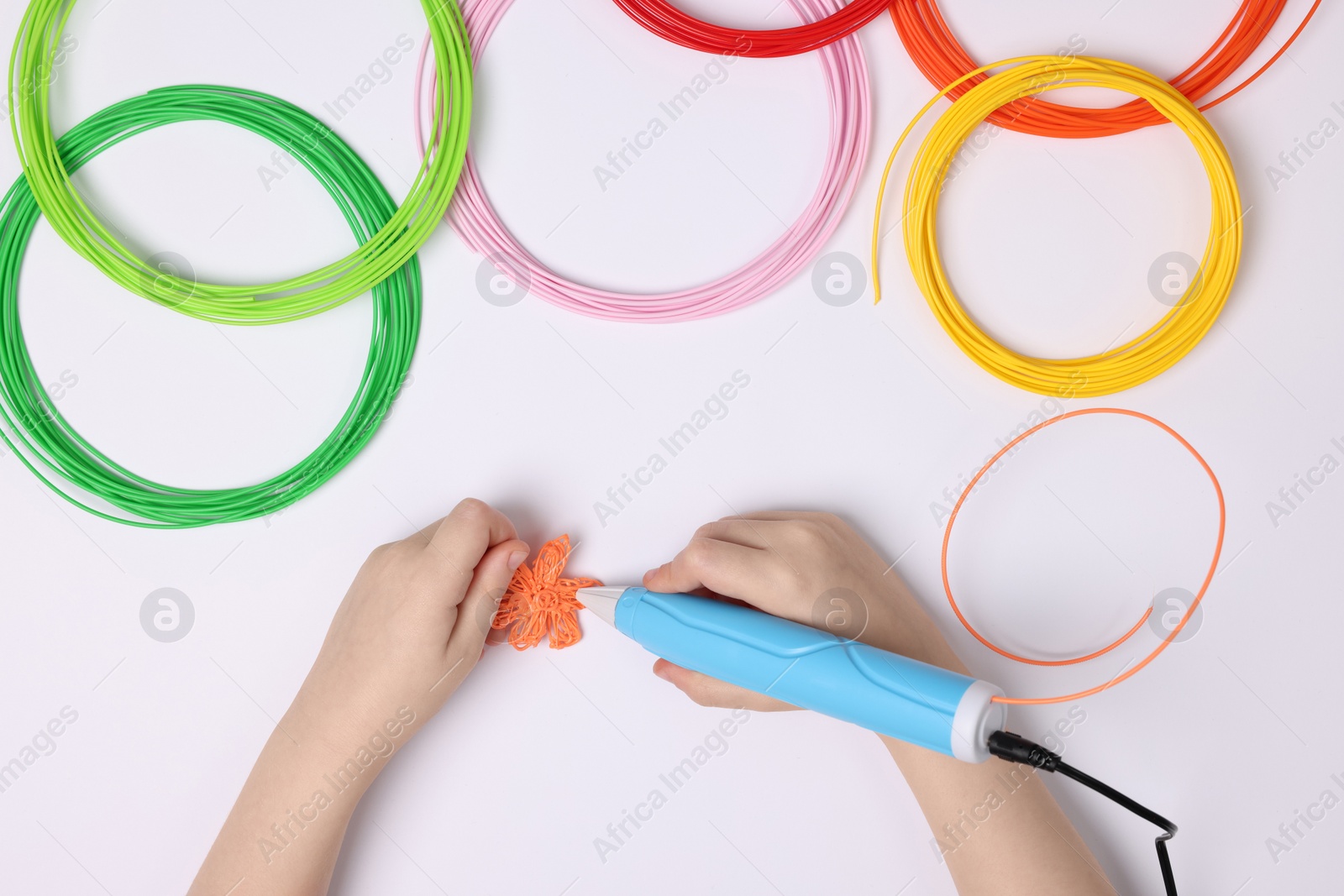 Photo of Boy drawing with stylish 3D pen on white background, top view