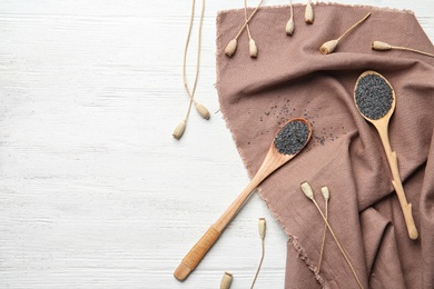 Photo of Flat lay composition with poppy seeds on wooden background