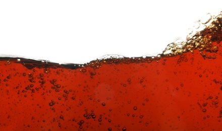 Closeup view of tasty refreshing cola on white background