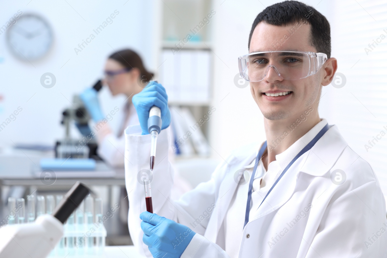 Photo of Scientist dripping sample into test tube in laboratory