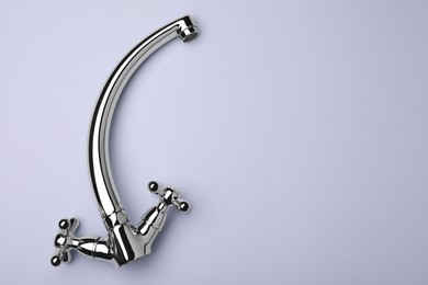 Photo of Double handle water tap on grey background, top view. Space for text