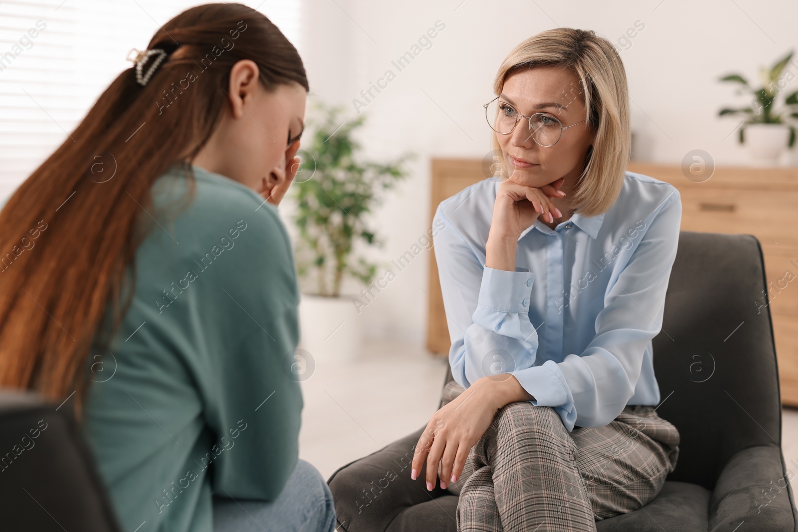 Photo of Professional psychotherapist working with patient in office