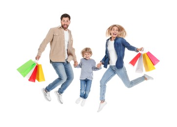 Family shopping. Happy parents and son jumping with many colorful bags on white background