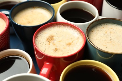 Many cups of different coffee drinks on table