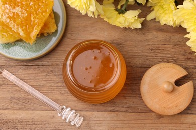 Flat lay composition with sweet golden honey in jar on wooden table