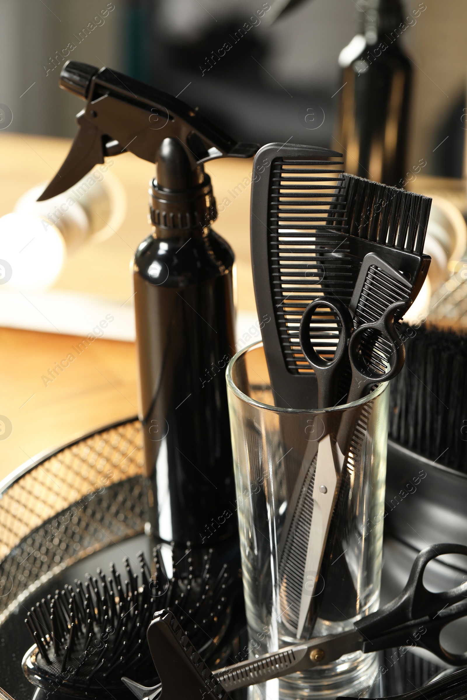 Photo of Set of hairdresser tools in salon, closeup