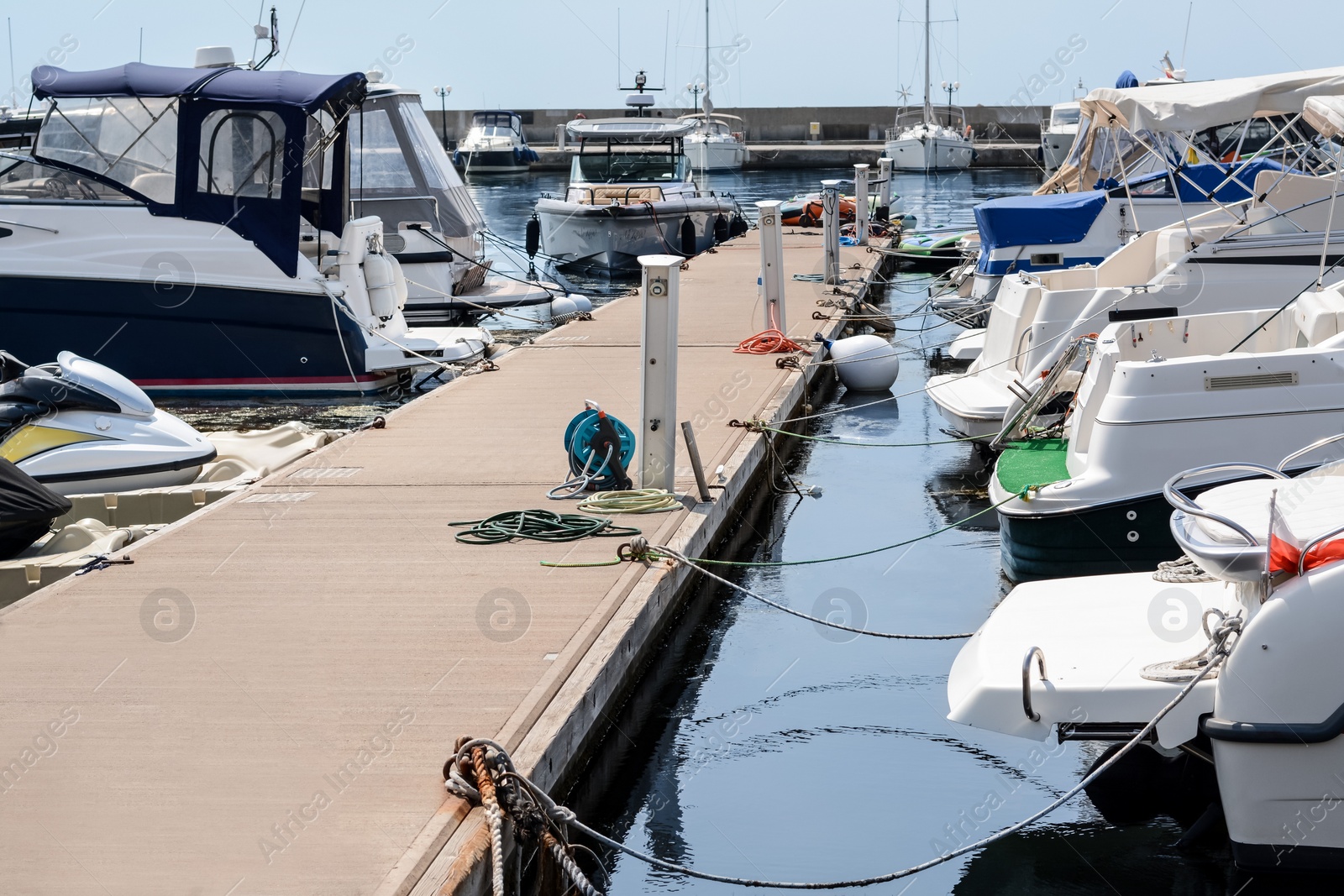 Photo of Beautiful view of city pier with moored boats on sunny day