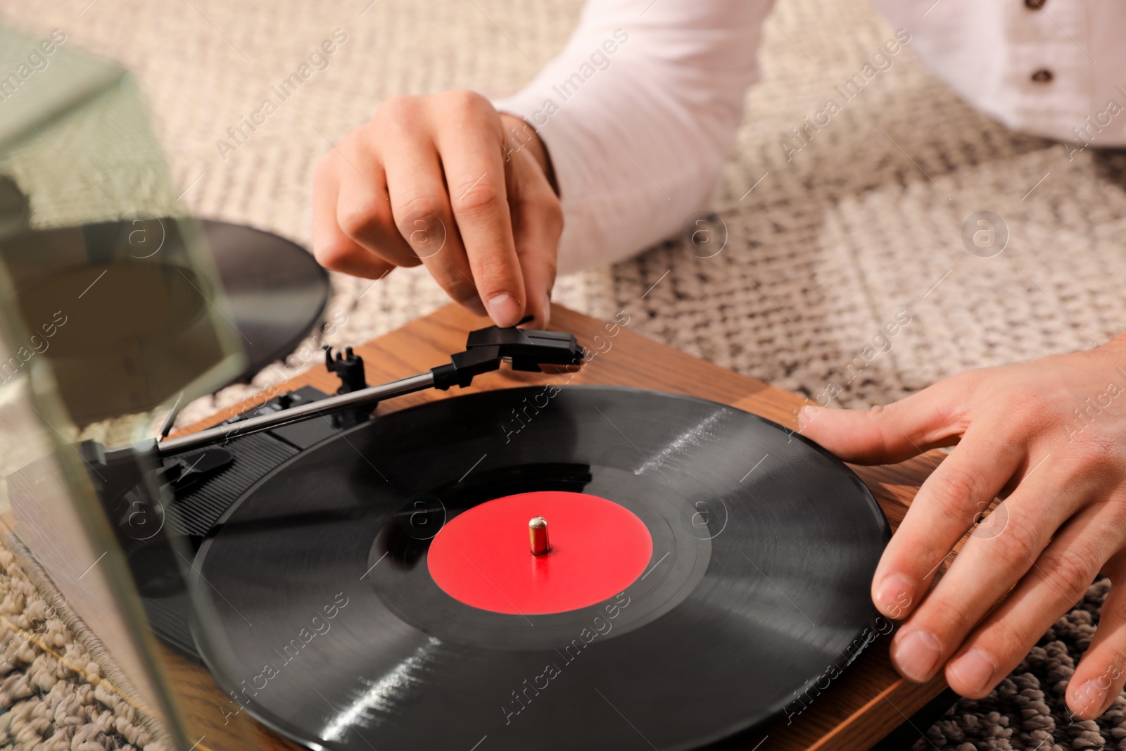 Photo of Man using turntable at home, closeup view