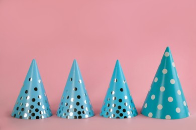 Light blue party hats on pink background