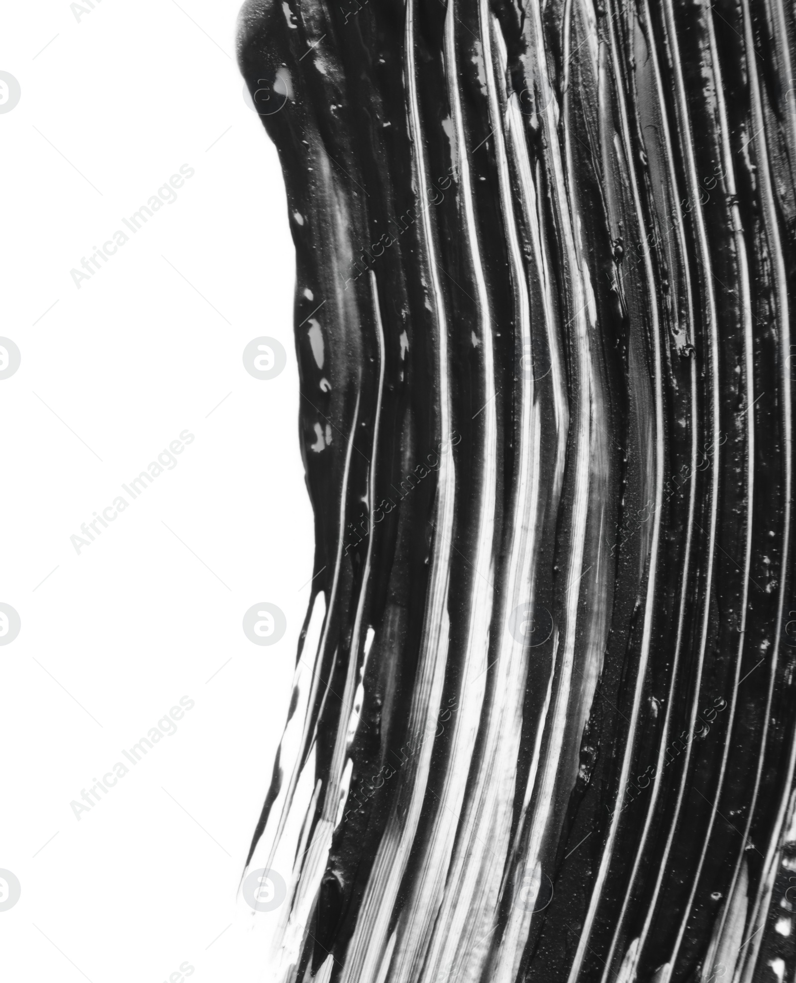 Photo of Smear of black mascara isolated on white, top view