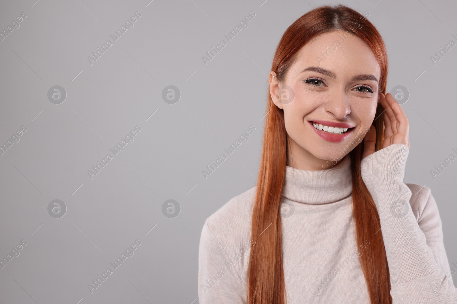 Photo of Portrait of beautiful young woman on light gray background, space for text